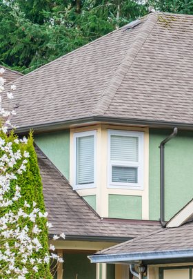 Roofer installing asphalt shingles in Highlands Ranch